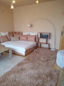 a living room with a couch and a table at Apartament na kurzej stopce in Malbork