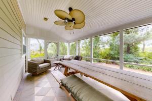 a dining room with a table and a ceiling fan at Creekside --- 57 Tributary Lane in Millville