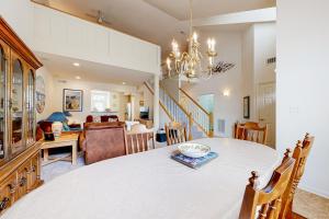 a dining room and living room with a table and chairs at Creekside --- 57 Tributary Lane in Millville