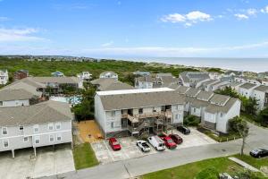 an aerial view of a house with cars parked in a parking lot at La LuNa in Corolla