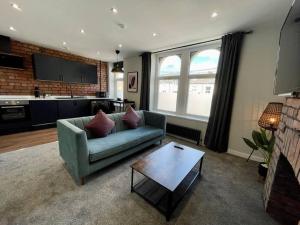 a living room with a couch and a coffee table at Stylish central apartment for 2 people free parking in Cardiff