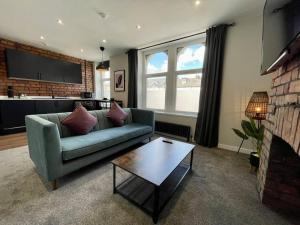 a living room with a couch and a coffee table at Stylish central apartment for 2 people free parking in Cardiff