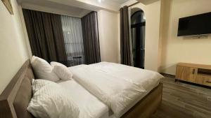 Ένα ή περισσότερα κρεβάτια σε δωμάτιο στο Altunyan Hotel