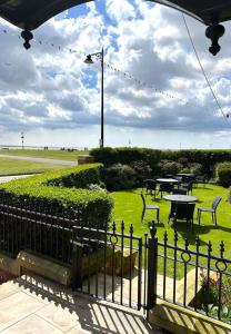 a wrought iron fence with a picnic table in a park at Clifton Arms Hotel in Lytham St Annes
