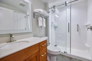 a bathroom with a shower and a toilet and a sink at TownePlace Suites Medford in Medford