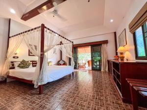 a bedroom with a canopy bed in a room at Cruiser Island By Swiss-Belhotel in Ko Lone +37 photos