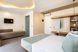 a bedroom with a large bed and a couch at Green Bay in Limenaria