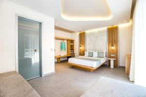 a bedroom with a bed and a sliding glass door at Green Bay in Limenaria