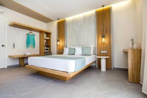 a bedroom with a large white bed in a room at Green Bay in Limenaria