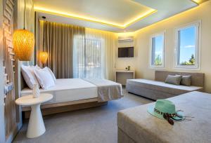 a hotel room with a bed and a couch at Green Bay in Limenaria