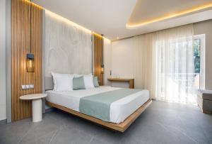 a bedroom with a large bed and a window at Green Bay in Limenaria