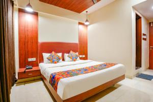 a bedroom with a large bed in a room at FabHotel D69 Residency in Mire