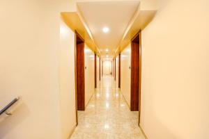 a corridor of a hallway with a long hallway at FabHotel D69 Residency in Mire