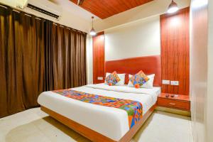 a bedroom with a large bed in a room at FabHotel D69 Residency in Mire