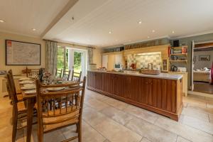 a kitchen and dining room with a table and chairs at Masongill Lodge in Cowan Bridge