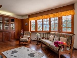 a living room with a couch and a chair at Apartment Aigle by Interhome in Sarre