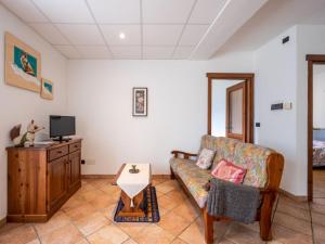 ein Wohnzimmer mit einem Sofa und einem TV in der Unterkunft Apartment Renard by Interhome in Sarre