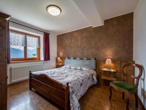 a bedroom with a bed and a table and a chair at Apartment Renard by Interhome in Sarre