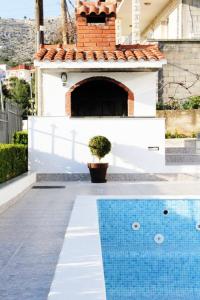 a swimming pool in front of a house at Apartment M in Seget Vranjica