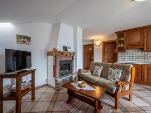 a living room with a couch and a fireplace at Apartment Marmotte by Interhome in Sarre