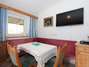 a living room with a table and a red couch at Apartment Monika-2 by Interhome in Gattererberg