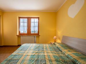 a bedroom with a bed in a yellow room at Apartment Hérisson by Interhome in Sarre +28 photos