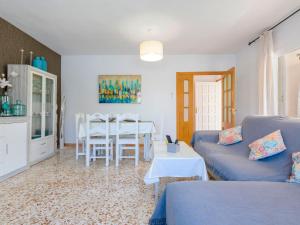 a living room with a blue couch and a table at Villa Villa Lolin by Interhome in Vinaròs