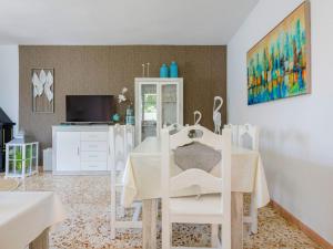 a dining room with a white table and chairs at Villa Villa Lolin by Interhome in Vinaròs