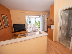 a view of a living room with a television and a kitchen at Apartment Bencun-2 by Interhome in Makarska