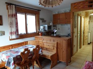 a kitchen with a table and a table and chairs at Apartment Namasté by Interhome in Les Villards-sur-Thônes