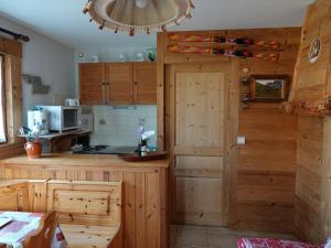 eine Küche mit Holzschränken und einer Arbeitsplatte in der Unterkunft Apartment Namasté by Interhome in Les Villards-sur-Thônes + 40 Fotos