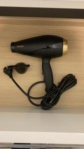 a hair dryer sitting on top of a shelf at Maison Divon in Montagne +50 photos