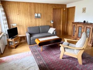 a living room with a couch and a table at Apartment Akelei - klein by Interhome in Zweisimmen