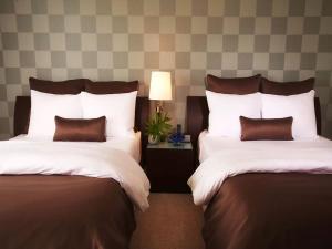 a hotel room with two beds with pillows at Apartment Provident Doral at The Blue-7 by Interhome in Miami