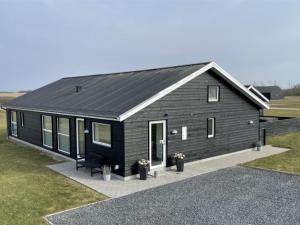 ロッケンにあるHoliday Home Dwerg - 1-5km from the sea in NW Jutland by Interhomeの黒屋根の黒家