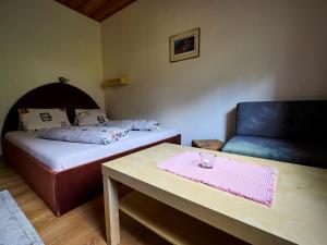 a room with two beds and a table and a couch at Apartment 547-3 by Interhome in Harrachov