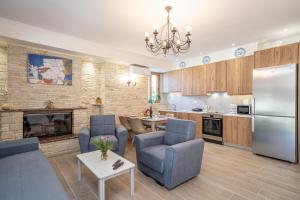 a kitchen and living room with a couch and a refrigerator at Ilias Apartments in Sami