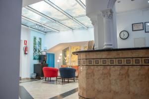 un salon avec une horloge au plafond dans l'établissement Hotel Agur, à Fuengirola