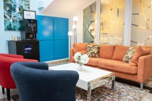 a living room with two couches and a coffee table at Hotel Agur in Fuengirola