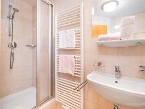 a bathroom with a sink and a shower at Apartment Rosa-9 by Interhome in Mayrhofen