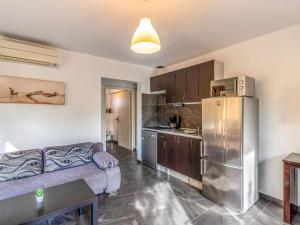 cocina con sofá y nevera de acero inoxidable en Apartment Marina di Favone-4 by Interhome, en Conca