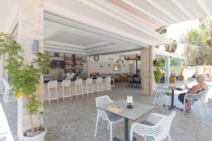 a woman sitting at a table on a patio at Bronze Hotel in Oludeniz