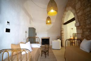 a bedroom with two beds and a fireplace at Masseria Soluco in Monopoli