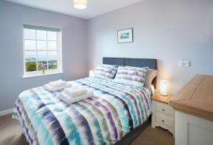 a bedroom with a bed and a desk and a window at Rhiwelli in Dinas