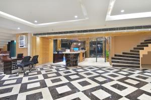 an office with a lobby with stairs and chairs at Hotel Vanson Delite - New Delhi Railway Station in New Delhi