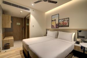 Posteľ alebo postele v izbe v ubytovaní 7 Apple Hotel Pratap Nagar, Jaipur