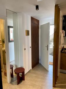 Una habitación con un pasillo con una puerta y un taburete. en Mar Jonica, 1 A2, en Denia
