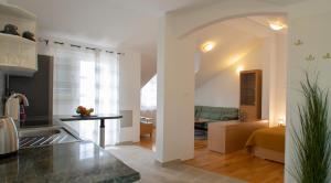 a kitchen and a living room with a couch at Mozart apartments in Baška Voda