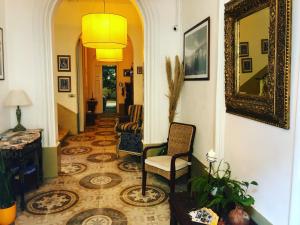 a hallway with a chair and a mirror at The Maltese Sun in Sliema