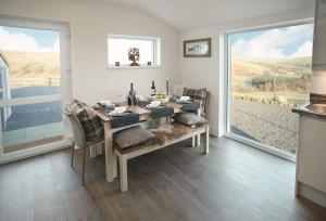 a dining room with a table and a large window at Corriedow in Thornhill